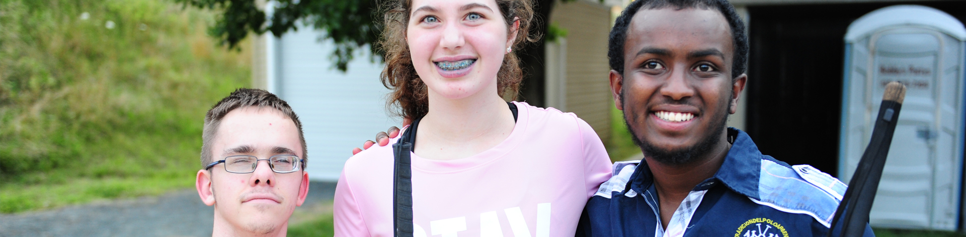 photograph of three students smile togather.